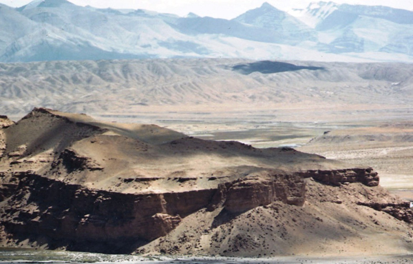 Fig. 7. The mesa on which the stronghold of Castle Face was built. The ruins are found all over the summit of this formation. In the background is the Sutlej river valley and mountains east of Castle Face