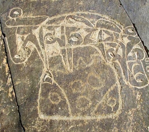 Fig. 11. A mascoid of more rectilinear proportions over which the six syllable mani mantra was carved. The variable levels of repatination exhibited by the mascoid and mantra are clearly recognizable. The lower part of the figure is ornamented with five circles. The internal features of the upper half of the mascoid have been largely obliterated by the letters. The superimposition of Buddhist inscriptions and motifs on earlier rock art is a common occurrence in Upper Tibet.