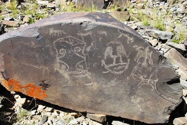 Fig. 14. Two later mascoids found at the epicenter of this genre of rock art. The shallow carving and style of companion animals indicate that this is another example of protohistoric period rock art. The artist was savvy enough to create his mascoids in both major head shapes: circular and rectangular. 