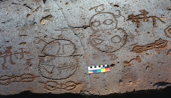 Fig. 6. These two mascoids were first documented in 2000 on the Upper Tibet Circumnavigation Expedition. The figure on the right holds what appears to be a bow in his left hand and there is something in the right hand of the left figure as well. Both mascoids are topped by curvilinear objects. They are surrounded by figures of a later period, including a horseman, a bowman and what appears to be three dorjes (rdo-rje, vajra), the adamantine thunderbolt of Tibetan Buddhism. The dorje is itself a seminal cultural symbol and placement next to the mascoids suggests their maker appreciated that they too once had great cultural significance. 