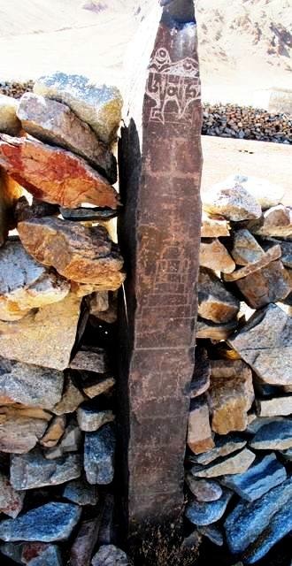 Fig. 7. On the top of the east face of this pillar (1.5 m in height) are the first three letters of the mani mantra below which a primitive or folk-style swastika (arms are much shorter than the central cross) was carved. In a more inferior position are two engraved chortens. The incomplete mani inscription was chiseled using an entirely different technique and exhibits much less wear and re-patination than the other carvings on the pillar. This physical evidence clearly indicates that the inscription was made more recently. Lone chortens and swastikas are found on walled-in pillars from other sites in the region as well. Nevertheless, the carving of such stelae was not common (for other examples, see Antiquities of Zhang Zhung: www.thlib.org/bellezza). 