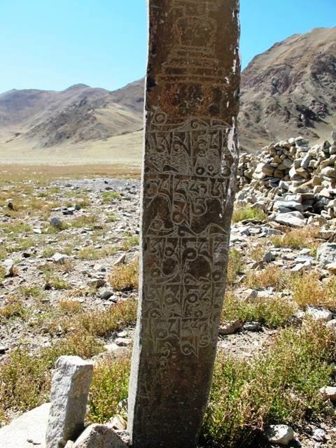 Fig. 9. This pillar is situated south of the corral and is 1.5 meters in height. It was engraved with two chortens and a much more recent mani mantra inscription sandwiched between them. The difference in the wear and patination between the inscription and chortens is dramatic. The upper chorten lacks a clearly defined spire. The two chortens (the lower specimen is barely discernable) date either to the early historic period or vestigial period.