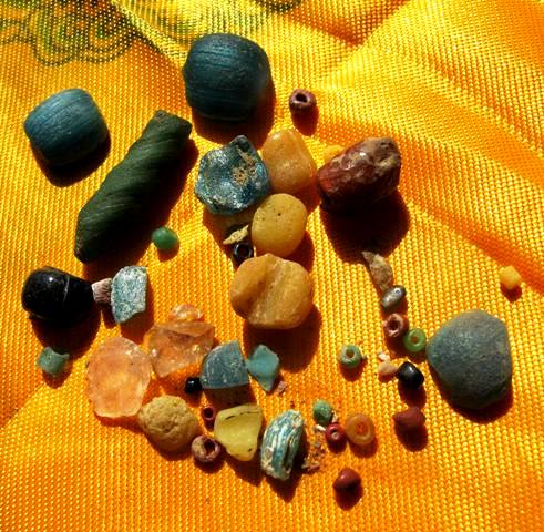 Fig. 14. A selection of semiprecious stone and glass beads recovered from Khardong by the sharp-eyed monks. This array of ornaments is remarkable for its sheer variety. The beads shown here represent diverse techniques of manufacture applied to a broad group of materials. These beads may date to different time periods. This variety in stones and glass is yet another potent sign that ancient southwestern Tibet was part of a far-ranging web of trade and exchange, one that encompassed sundry regions. I very much welcome the comments of readers, some of whom are liable to know more about ancient beads than I do. The function of the pieces of clear quartz and the dark-colored cylindrical stone in the image are unknown. 