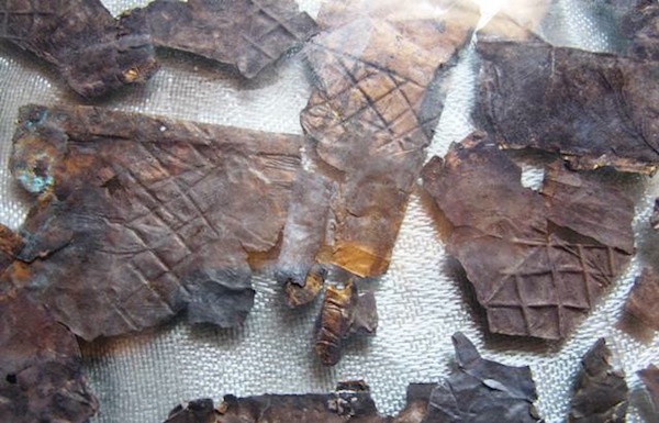 Fig. 8. Thin pieces of silver (?) embossed with diagonal lines. Some of these fragments appear to have been gilt. These fragments probably formed ornamental plates or sheathing. As with the copper, iron and copper-alloy items found in the same burial, these snippets are the handiwork of a people well versed in metallurgy and metalworking. 