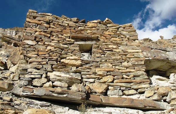 Fig. 11. The forward wall (2.1 m high) of the highest elevation individual residence at the site. It has been designated DK1. This small building (3 m x 1.7 m) was built into the layered rock of the formation. The window opening (40 cm x 35 cm) is supported by a stone lintel. However, on its interior side several small rounds of tamarisk (?) were added to the lintel assembly. 