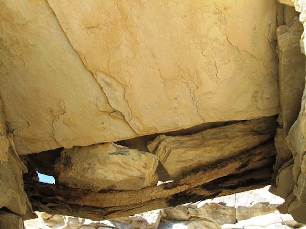 Fig. 12. A close-up of the lintel in DK 1. The cracked round of wood was extracted for radiocarbon testing. It yielded a date of circa 1450–1600 CE. In fact, its calibration curves very closely match that of the dated timber from Sector IV of the citadel. The pieces of wood used in DK I represent an improvisation, possibly added to weatherproof the wall around window opening. It appears that one of the stone slabs of the lintel had broken, creating a gap in the wall. The repair undertaken is rudimentary in character, a far cry from the original construction of the various individual domiciles and citadel. It would appear that far fewer economic resources were available to these later inhabitants of the site. Their tenure at the site appears to have been much more tenuous than when Sutlej River Valley Citadel was in its heyday. 