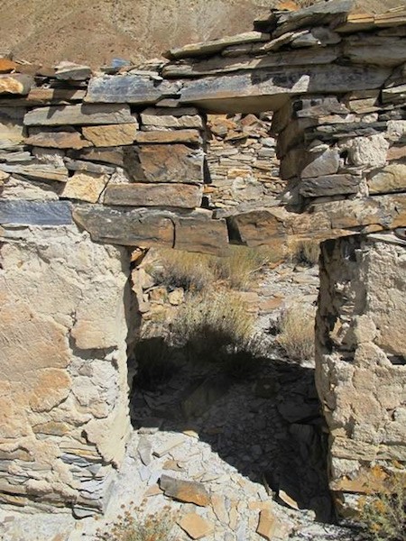 Fig. 6. An entranceway (90 cm x 60 cm) connecting two rooms in Sector I. This is one of the only entrances that remains intact in the ruined facility. The lintel (1 m long) has broken in half. Above it is an aperture (35 cm x 30 cm) with its own lintel. Doorways are typically small in the all-stone corbelled architecture of Upper Tibet. Much of the clay-based plaster is still affixed to the walls.