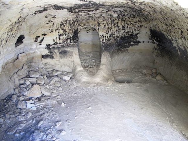Fig. 5. A typical cave of Regiment Valley and of all Guge. Note the deep central recess in the rear of the cave. Sometimes adobe hearths are found in front of this sui generis feature. Also note the fire-blackened walls. Caves such as this one were clearly occupied for significant periods of time. In ostensible archaic sites like Regiment Valley, very little of the soot depositions remain adhering to the ceiling. In caves occupied during the Buddhist era, this soot often forms a thick, well agglutinated layer on ceilings.