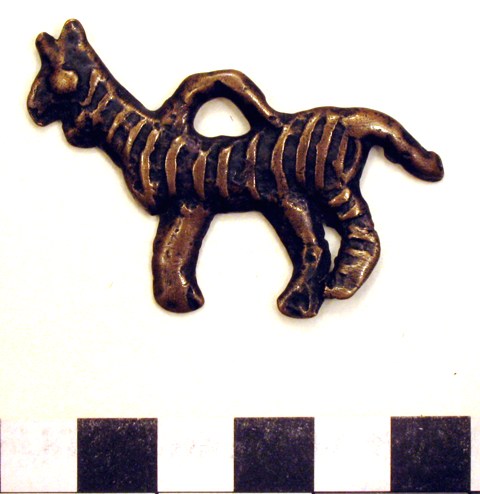 Fig. 11. A copper alloy tiger talisman designed to be hung from the body, early historic period or vestigial period. Tiger thokchas are not particularly common. This specimen has a rather cartoonish character. Private collection, photograph by author.