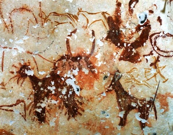 Fig. 1. This is an excellent example of an ancient palimpsest, eastern Changthang. Three animals created by thickly applying blood-red ochre onto a cave wall partially obscure older hunting scenes and other zoomorphic art.