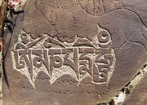 Fig. 13. In this image there is rock art of three different periods represented by the equid (?), tiered shrine and mani mantra, northwestern Tibet.