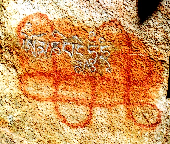 Fig. 16. A red ochre endless knot (dpal-be’u) defaced by a carving the seven-syllable mani mantra. Here, too, the presence of the mantra suggests that this auspicious symbol belonged to the adherents of archaic religious traditions, the addition of the mantra a kind of purging of the past.