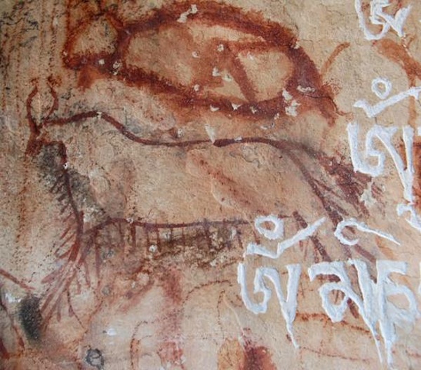 Fig. 6. Another cave with mantras carved by pilgrims and local residents on rock surfaces hosting ancient art, west side of Lake Nam Tsho. As a result, much art has been disfigured at this site, paintings that only a few years ago were still in excellent condition.