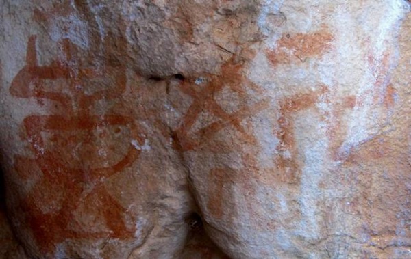 Fig. 9. From left to right: tabernacle (14 cm in height), five-pointed star and two counterclockwise swastikas, eastern Changthang. This vase-like tabernacle has a high pedestal and a half circle midsection connected by a narrow neck to a broad top, which is surmounted by three protuberances. It probably dates to the early historic period, as a minor inscription found nearby exhibiting similar pigment and wear qualities indicates.