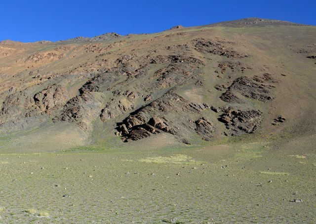 Fig. 1. The mountain of Thakhampa Ri. The rock art site is the dark pyramidal outcrop near the base of the mountain (middle of photograph).