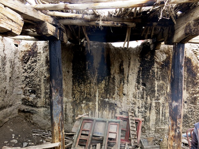 Fig. 14. The interior of the old house of the jowa, Tashigang. Very little of the roof remains intact.