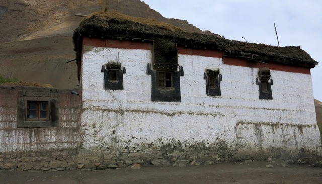 Fig. 18. The north side of the Tenzin Tsultrim residence, Key. Note the different-sized windows, each with complex denate lentils. Above the band of red ochre is a tamarisk cornice and above that brush is stacked on the roofline.