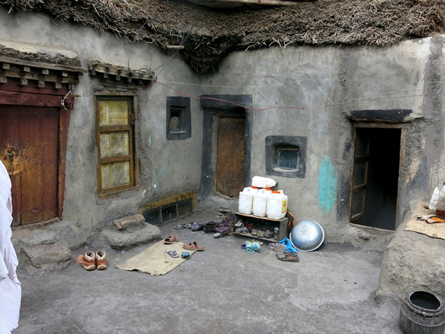 Fig. 19. The patio on the second floor of the Tenzin Tsultrim house. The entranceway to the patio is on the extreme right. The middle right door leads to a small sleeping room. The middle left door accesses the new summer kitchen and the large doorway on the extreme left is the old summer kitchen.