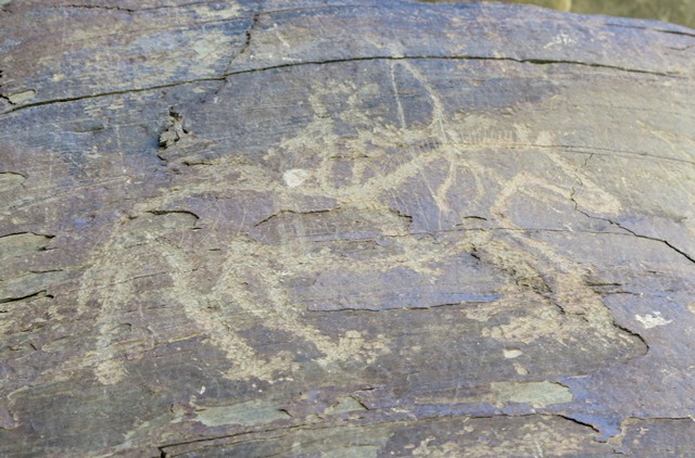 Fig. 25. A mounted archer (25 cm long), Sumdo 1. Many of the anatomical details of the horse and rider were rendered in this realistic carving. The horseman is in pursuit of a wild ungulate (not shown in image). Early Historic period or later.