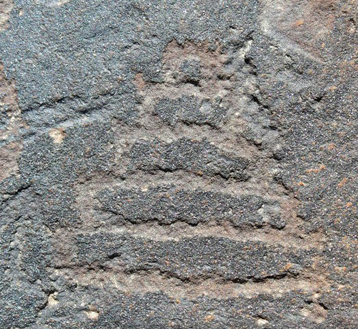 Fig. 53. A shrine of five tiers (12 cm high) carved on top of a boulder, Lari Tingjuk. This petroglyph closely resembles fig. 44 in form. On the top of the same boulder are two suns. Protohistoric period.
