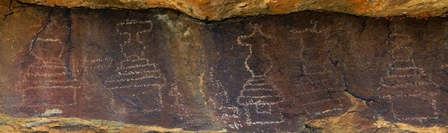 Fig. 69. Six (one is incomplete) of nine or ten chortens aligned in a horizontal row, each rendered in a different style (12 to 15 cm in height), Shelatse. These chortens were lightly etched in the rock. Early Historic or Vestigial period.