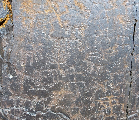 Fig. 6.3. Left side of the same rock face shown in fig. 6.1. Here we see a variety of carvings, all of which put male figures in close proximity to wild ungulates.
