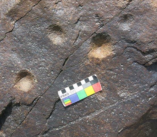 Fig. 11.55. Cup-marks carved into the surface of a boulder. These marks are heavily re-patinated and of significant age.