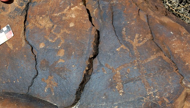 Fig. 14.31. Anthropomorph with arms raised and widely spread legs (right). Early Historic period. On the left side of the boulder are two clockwise swastikas and star (bottom) that can also be dated to the Early Historic period. Above the star there is an older petroglyph resembling an anthropomorph.