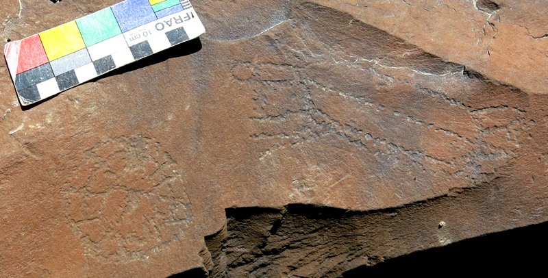 Fig. 14.50. Two geometric subjects, one round with a spoked pattern and one oval with radiating lines, which appear to have been engraved in the rock together. Protohistoric period.