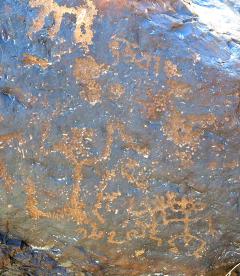 Fig. 18.30. Three figures of the right side of the boulder in fig. 18.29. They appear to be dancing or engaged in some other ceremonial or celebratory activity. At the top of the image is a Tibetan inscription also of the Early Historic period. It reads: rta-zog (horse requisitions). There is a Tibetan inscription at the bottom of the image as well but it is less legible. The first three characters possibly read: gsang (secret).