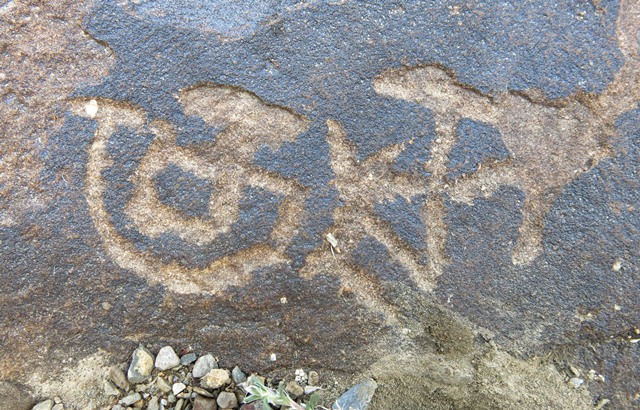 Fig. 2. The two carvings were made on a boulder with older zoomorphic petroglyphs. This boulder is located in the uppermost part of District Kinnaur, across the Spiti river from lower Spiti.
