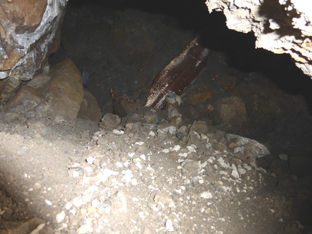 Fig. 16. Shaft tomb opened in Mani Gongma in fig. 13. Note the wooden plank, which was part of a coffin or some other mortuary structure. Photo courtesy of SRAHS.