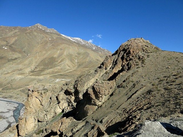 Fig. 21.2. The defile around Jomo Phuk. The cave is located in the lower left half of the image behind the largest shadow. On top of the rocky knob to the right are the poorly preserved ruins of what is said to have been a Buddhist monastery.