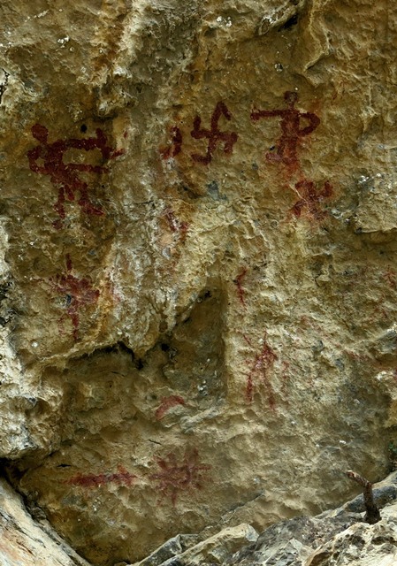 Fig. 26.2. One of the rock faces at Thonsadrak 1. On the upper portion of the panel are two anthropomorphs flanking a swastika and crescent moon (partially effaced). Below the anthropomorph on the right is another swastika. On the lower part of the panel is a sunburst and horizontal line.