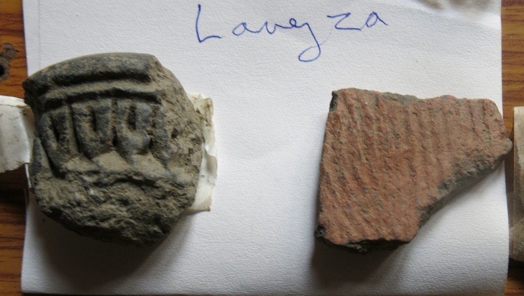 Fig. 35. Two sherds of pottery collected by the SRAHS in Langdza. The cord-marked buffware fragment on the right is of a type that was used in mortuary rites (non-funerary functions for these ceramics may also be indicated). The thick-walled greyware fragment on the left with its stamped or molded decorations is of a type that is probably of much more recent manufacture.