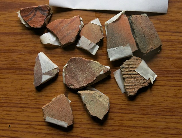 Fig. 53. An assortment of earthenware sherds collected in Rangthang. The wheel-turned painted pottery and other fragments in the upper row are from more recent types of ceramic vessels. The cord-marked fragment of buffware on the right side of the middle row may be a mortuary ceramic.