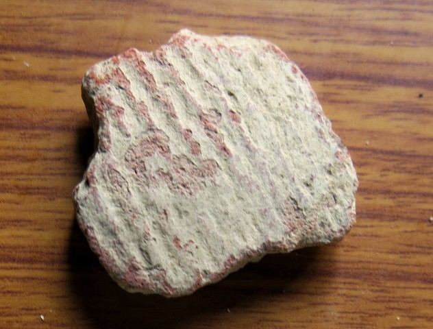 Fig. 60. Cord-marked sherd collected in Hanse (Han-se). This ancient fragment may have been deposited in a mortuary context. Note the white encrustation on the surface of this ceramic. These depositions on pottery usually contain carbonates (CO₃).