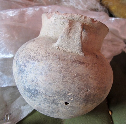 Fig. 65. A smooth-walled globular jar with flaring neck and strap handle (12 cm in height) discovered in the same Gurgyam burial as fig. 64.