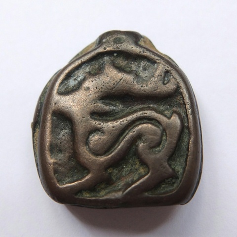 Fig. 7. Small Tibetan thokcha embossed with stag in the Eurasian animal style (2.2 cm x 2.2 cm). Iron Age or Protohistoric period. Carol Yong collection, Hong Kong. Photo courtesy of Carol Yong.