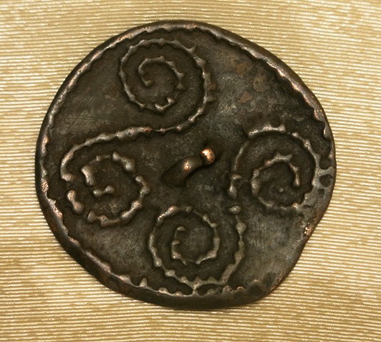 Fig. 11. A disc-shaped thokcha with a pair of nubbed scrolls and thin attachment loop in the middle (approximately 70 cm in diameter) of the object. The rim of the object is similarly nubbed. This object is probably from the Tibetan plateau. Late Bronze Age or Iron Age. Amdo Tsegyal (A-mdo tshe-rgyal) collection, Amdo.