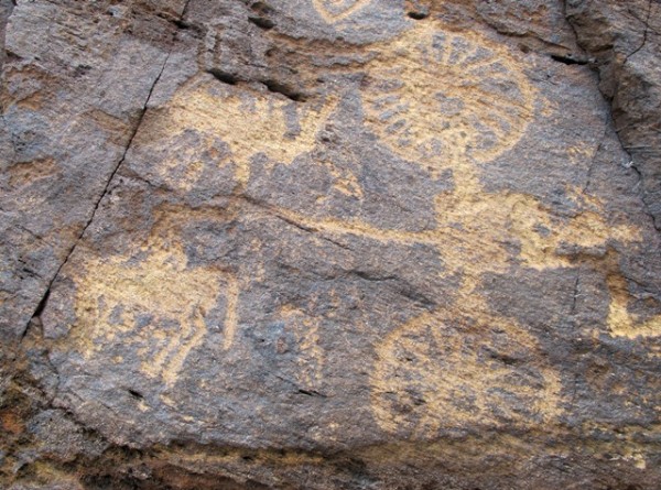 Fig. 14. Engraved chariot with charioteer in the square box (the Z-shaped line on the extreme right side is part of another carving). This chariot petroglyph has wheels with 20 or more spokes and is pulled by two horses. Upper Tibet.