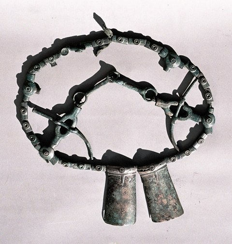 Fig. 29. Horse bridle with coverlids and sockets for the reins, curved plates (ostensibly part of the headstall assembly or phalera ornamentation), two-piece bit, and cheek pieces (components not oriented correctly in photograph). Tibet Museum, Lhasa.