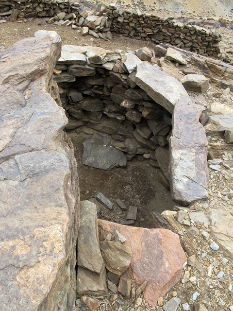 Fig. 7. A view of the one intact upper tier room in Rock Art Village. Note the in situ roof slab (foreground) and bridging stone (right side). These lithic members originally rested on corbels, most of which are now missing. It can also be seen how deeply set into the ground the room is. This would have made it easy to heat and enhanced its structural integrity and durability.
