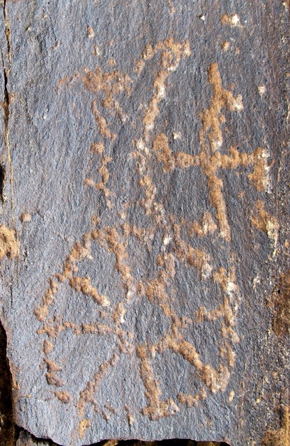 Fig. 2. This carving of the crescent moon, swastika and sun is found in western Tibet. The sun with a spoked design is characteristic of Upper Tibetan rock art. Probably Iron Age.