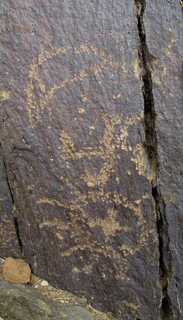 Fig. 8. Here again a swastika is flanked by the sun and crescent moon, western Tibet. As in fig. 6, the sun is divided by a cross into four sections. Figs. 2, 6, 8 are found at the same large rock art site.