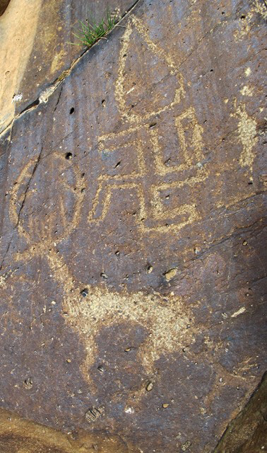 Fig. 15. Swastika, animal and highly obscured figure(s) set between two primitive stepped shrines. Another red ochre swastika is visible on the right side of the image. Protohistoric period. Although several different compositions may be involved, the swastika and other pictographs were made in the same general period and communicate interrelated religious themes.
