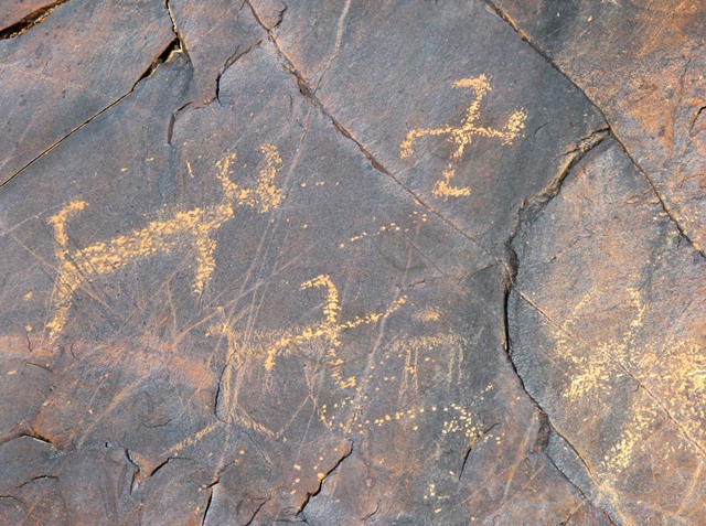 Fig. 20. Two swastikas and two wild yaks (specimen on right partly visible in image). Protohistoric period. Here once again the link between the wild yak and swastika is demonstrated.