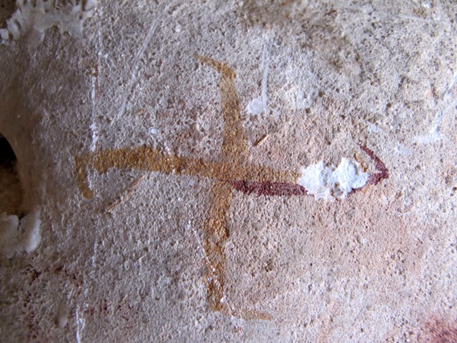 Fig. 27. What appears to be a swastika depicted in isolation in the same cave as figs. 1 and 26. Nevertheless, a welter of other figures is not far away. Note the use of both yellow and red ochre. Eastern Changthang. Iron Age.