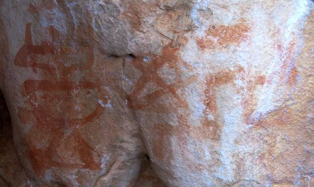 Fig. 48. Pictographic shrine, swastikas and star of same kind as fig. 39, eastern Changthang. Early Historic period. Above the pictographs illustrated is one or two short inscriptions, together reading A hung (second syllable with both consonants and vowel sign fully written out). These two syllables were inscribed in a similar red ochre pigment and exhibit wear characteristics comparable to the shrine, swastika and star, indicating that they were all made in the same time frame.