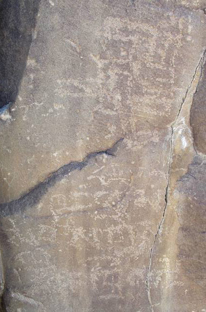 Fig. 49. Large counterclockwise swastika and what appears to be an incomplete swastika carved above an inscription reading: Khyung pho ma…bris (“Written by Khyung pho…”), northwestern Tibet.